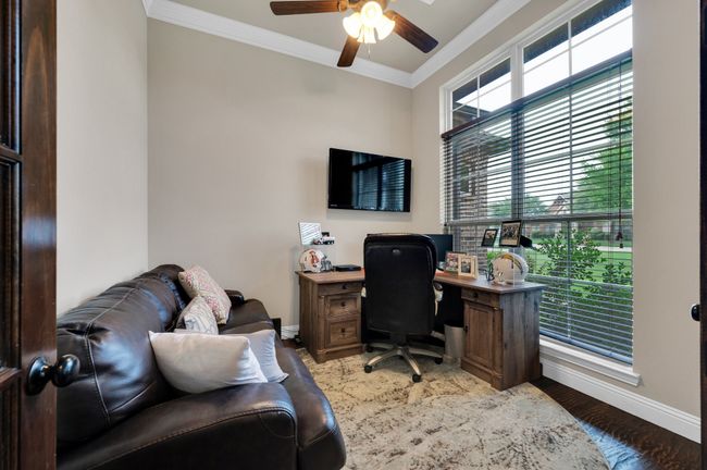 Office featuring baseboards, a ceiling fan, crown molding, and light wood finished floors | Image 23