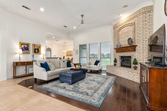 Wood flooring & recessed lighting in the main living area downstairs. | Image 5
