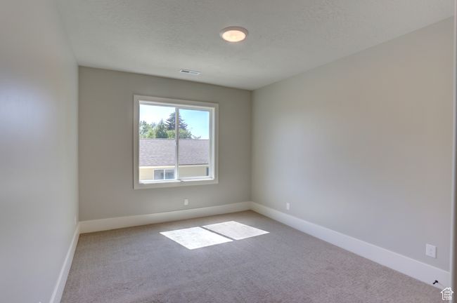 Empty room with light carpet and a textured ceiling | Image 24