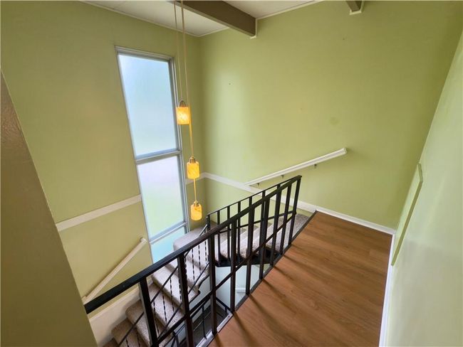Stairs with wood finished floors and baseboards | Image 10