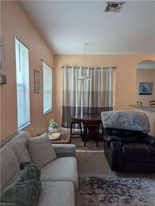 Living room featuring arched walkways and carpet flooring | Image 25