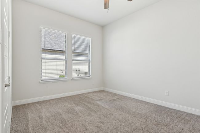 Carpeted spare room featuring baseboards and a ceiling fan | Image 34