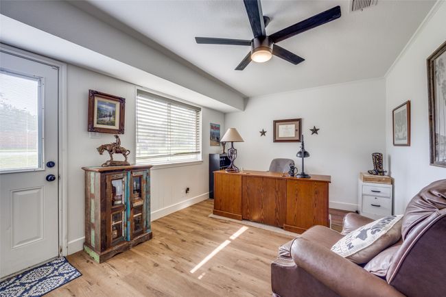 Office with a ceiling fan, light wood-style floors, and baseboards | Image 9