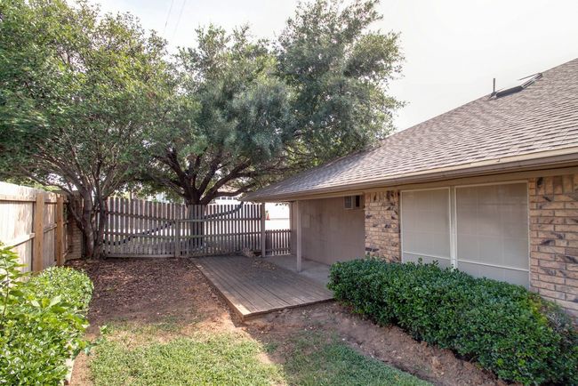 Fenced backyard with a deck | Image 23