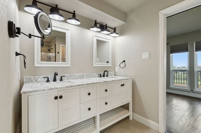 Bathroom featuring double vanity, baseboards, and a sink | Image 20