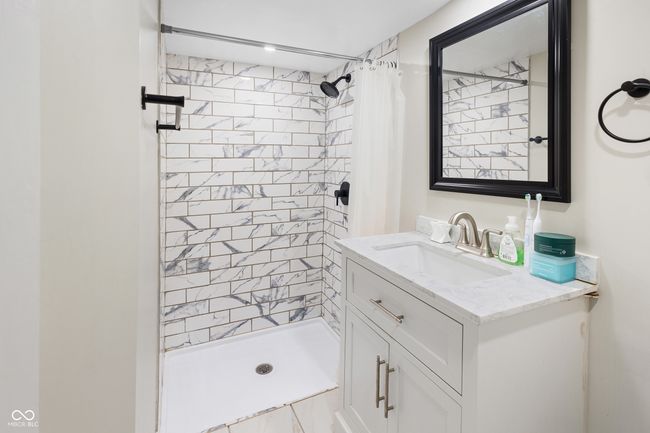 full bath featuring a shower stall and vanity | Image 17