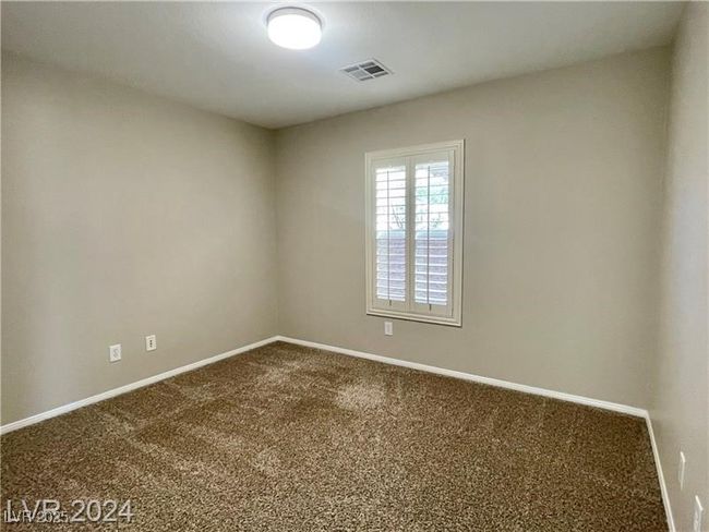 Carpeted spare room featuring baseboards and visible vents | Image 17