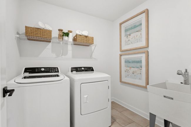 (Photo of a decorated model, actual homes finishes will vary) Upper level laundry. | Image 22