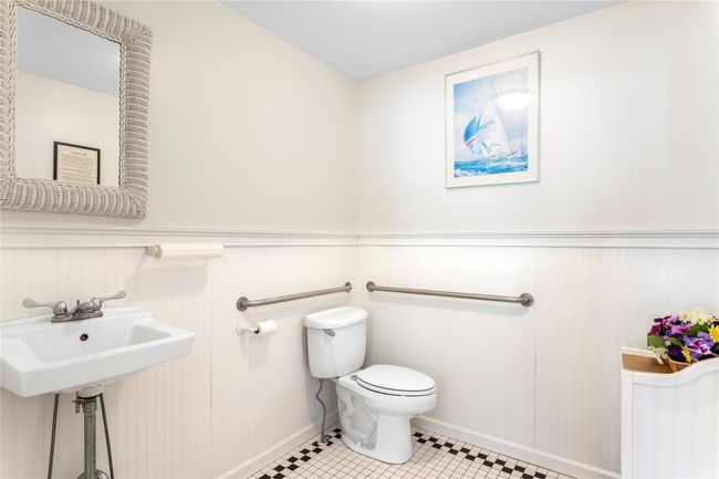 Bathroom with tile patterned flooring, wainscoting, and toilet | Image 14