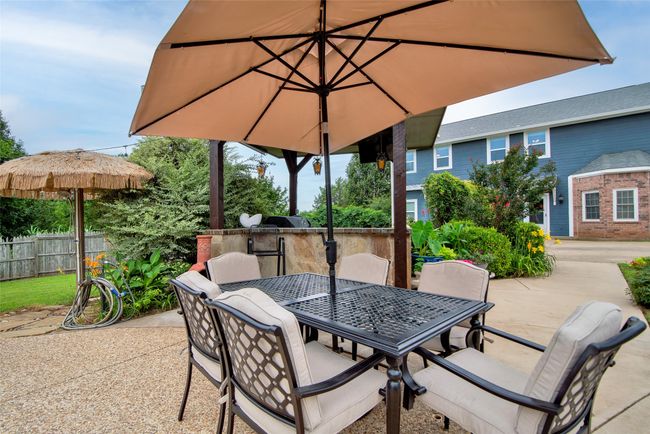 View of outdoor kitchen and outdoor shower on the left (under the umbrella) | Image 32