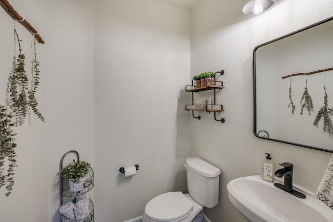 Half bath featuring toilet, a sink, and baseboards | Image 24