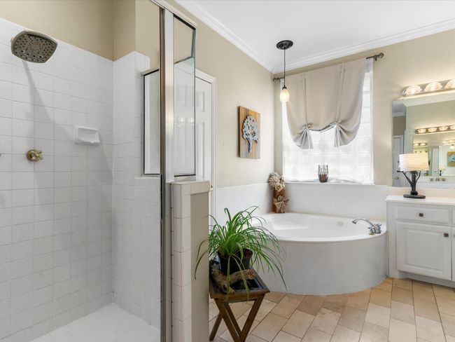 Full bathroom with a shower stall, vanity, a garden tub, and ornamental molding | Image 21