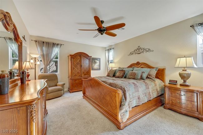 Bedroom with a ceiling fan and light carpet | Image 25