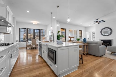 Large island with white quartz counter tops. | Image 3