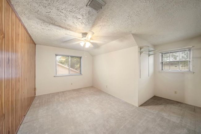 An alcove with built-in shelving offers flexible space for organizing, studying, or displaying decor. | Image 27