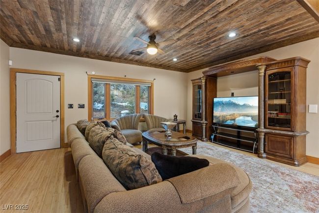 Living room with visible vents, baseboards, wood ceiling, light wood-style flooring, and recessed lighting | Image 29