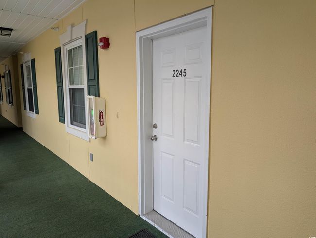 Doorway to property featuring stucco siding | Image 16
