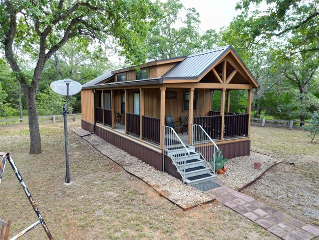 Back of property with a porch, board and batten siding, and a metal roof | Image 10