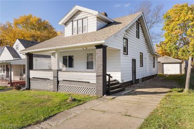 View of front of property with a garage, an outdoor structure, a front yard, and a porch | Image 3