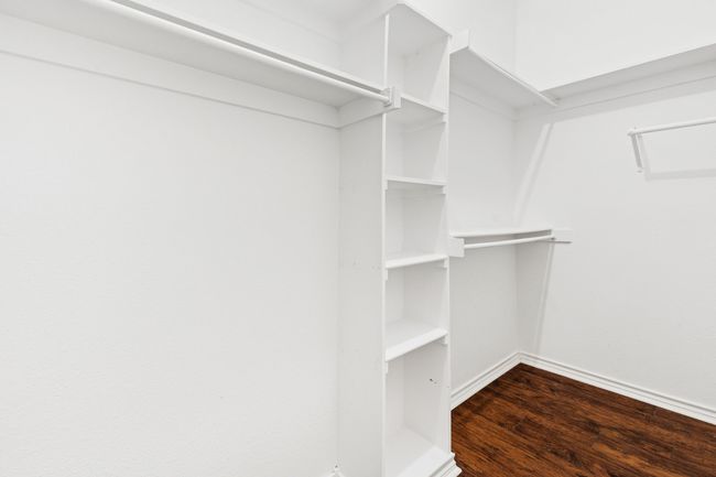 Walk in closet featuring dark wood-type flooring | Image 21