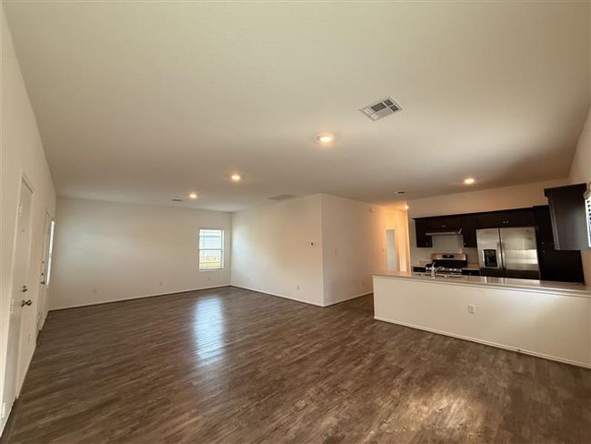 Unfurnished living room featuring dark wood-style floors, recessed lighting, and baseboards | Image 13