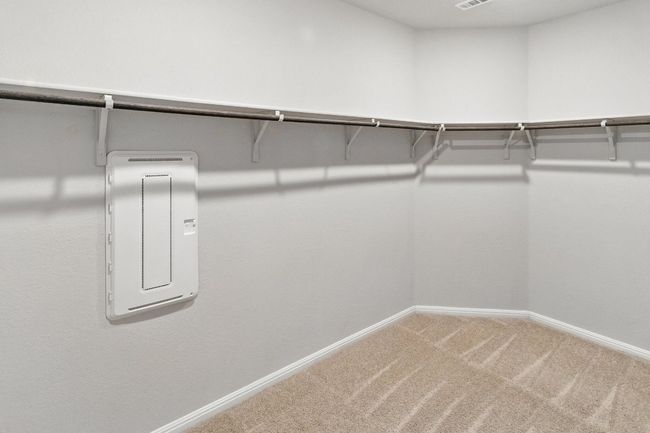 Walk in closet with carpet and electric panel | Image 15