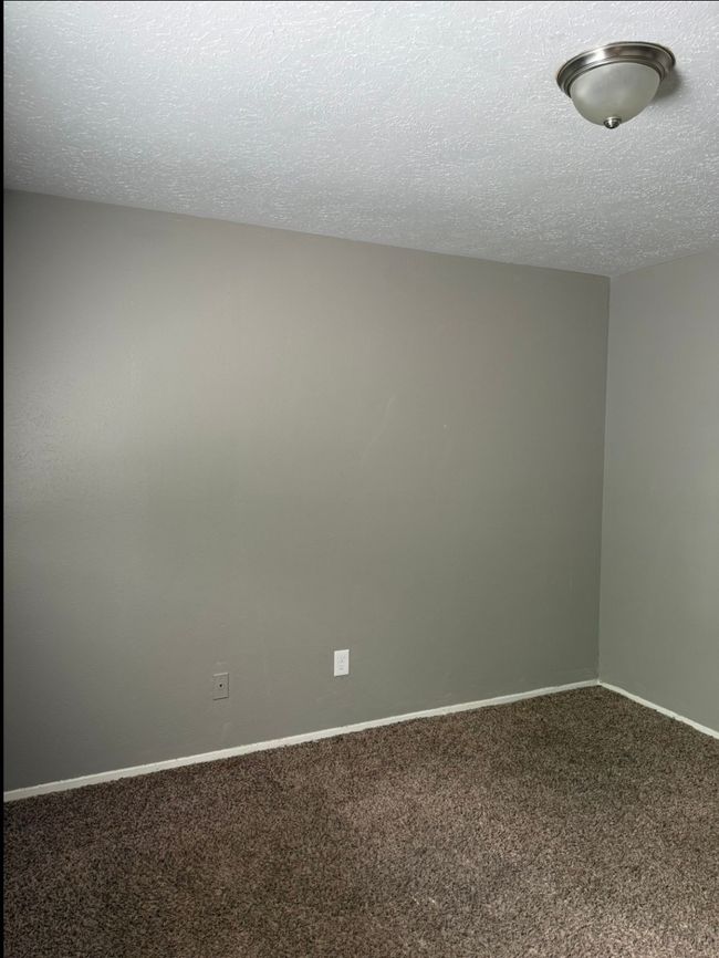 Carpeted empty room with a textured ceiling and baseboards | Image 19