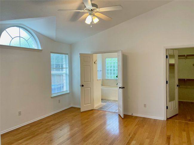 High ceiling primary bedroom, walk-in closet, arched window | Image 18