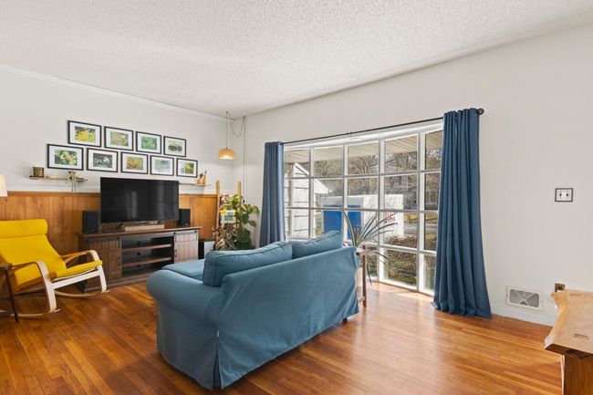 Living Room featuring a large bay window and hardwood floors throughout | Image 4
