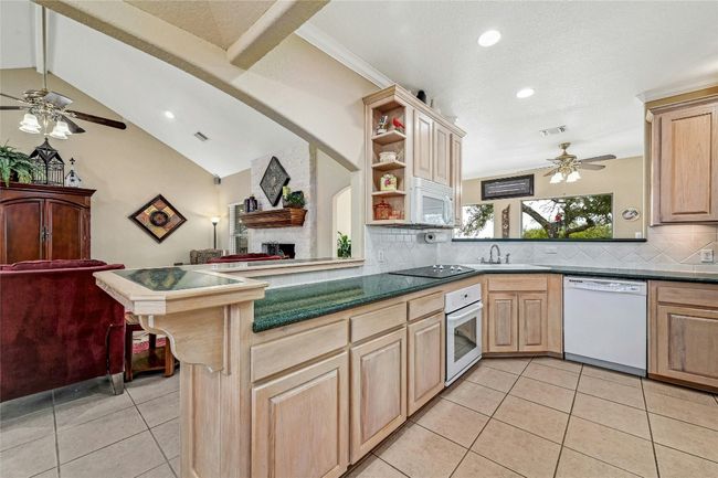 From the kitchen, its easy to enjoy nature. Just past the sink is the breakfast/flex room with its large picture windows. | Image 10