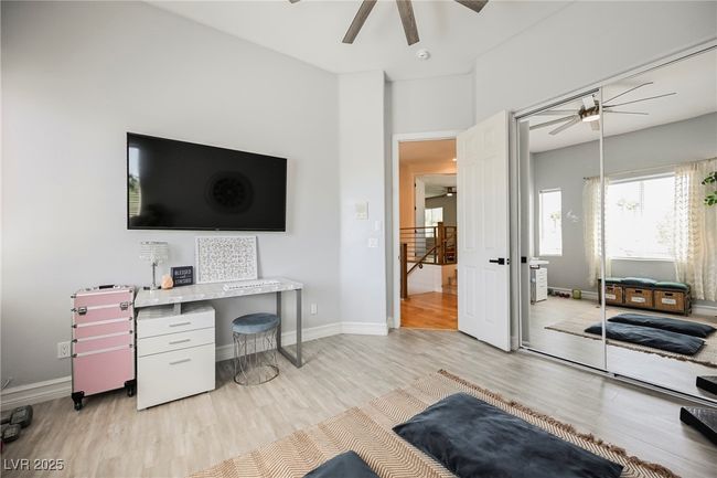 Bedroom featuring light wood-style floors, baseboards, and a ceiling fan | Image 49