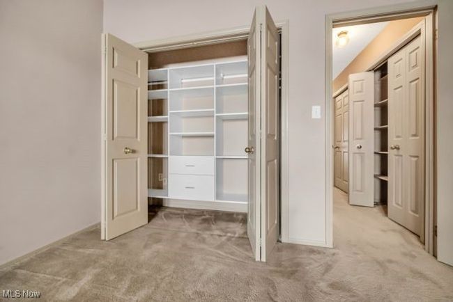View of fitted closet in the flex room which is down the hallway pictured to the right that has extra closets as well as the bathroom | Image 28