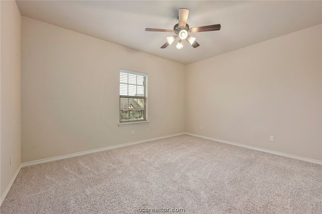 Carpeted empty room with a ceiling fan and baseboards | Image 17