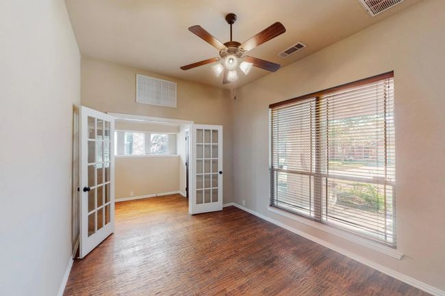 Spare room with french doors, wood finished floors, and a ceiling fan | Image 6