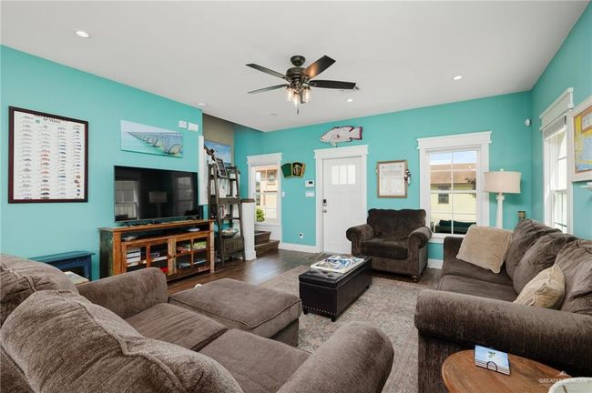Living room featuring light hardwood / wood-style flooring and ceiling fan | Image 8