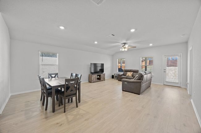Dining space with light wood-look flooring and open layout | Image 13