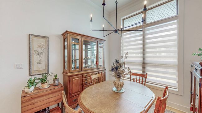 Dining space with a chandelier and crown molding | Image 14