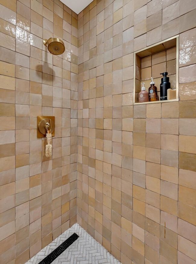 Primary bath featuring handmade designer tiled shower | Image 27