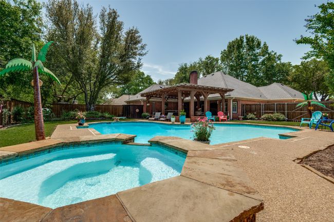 View of swimming pool featuring a patio, a fenced backyard, a pergola, and a lovely pool | Image 32