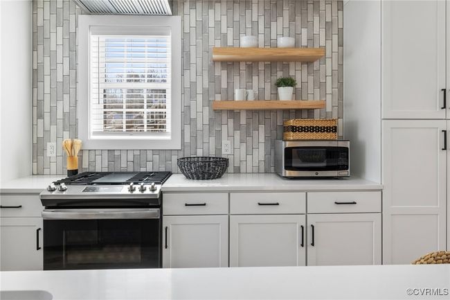 Lots of light and beautiful tile backsplash that extends to ceiling. | Image 13