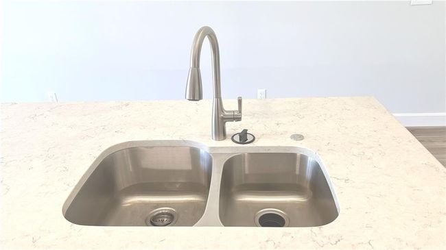 Kitchen view of light quartz counters and wood finished floors | Image 20