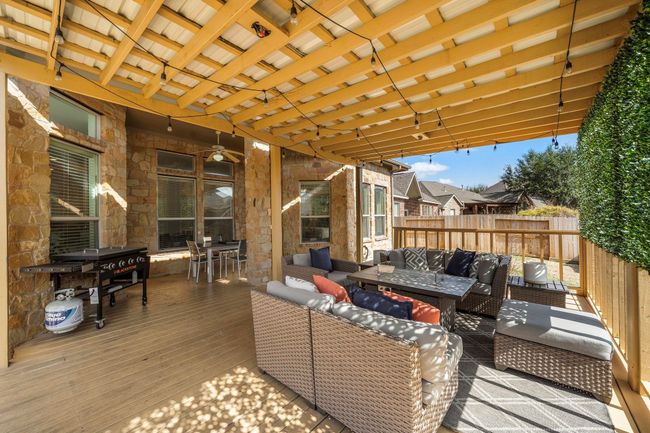 The cozy wood decking complements the stone accents of the home, providing a seamless transition between indoor comfort and tranquil outdoor living. | Image 35