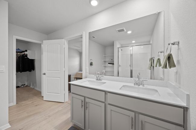 Ensuite bathroom with a double vanity, wood-look floors, and a walk-in shower | Image 20