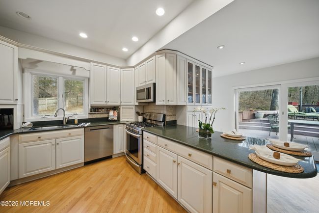 Eat in Kitchen with separate Dining, Coffee bar, SS appliances with sliders to LARGE deck with privacy and nature. | Image 6