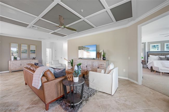 Living room with visible vents, ornamental molding, coffered ceiling, and ceiling fan | Image 15