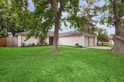 As you approach, notice the recent paint in a timeless yet refreshing palette and freshly manicured flower bed framing the entrance with bursts of vibrant blooms! | Image 2