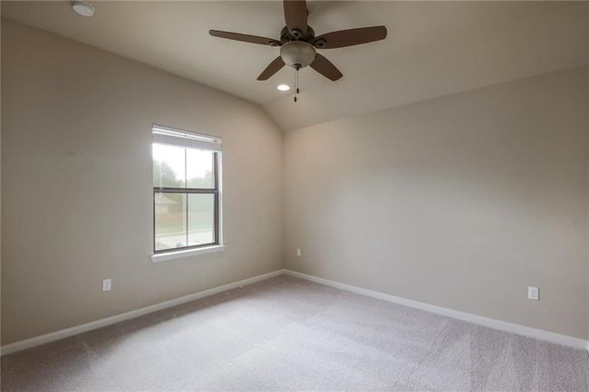 Unfurnished room featuring light carpet, ceiling fan, a smoke detector, lofted ceiling, and recessed lighting | Image 26