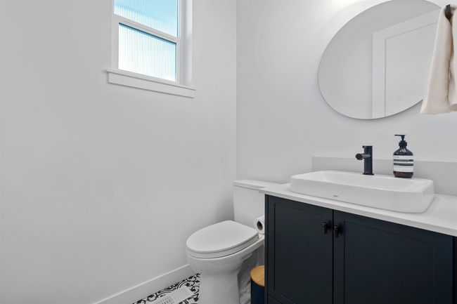 Bathroom featuring baseboards, toilet, and vanity | Image 15
