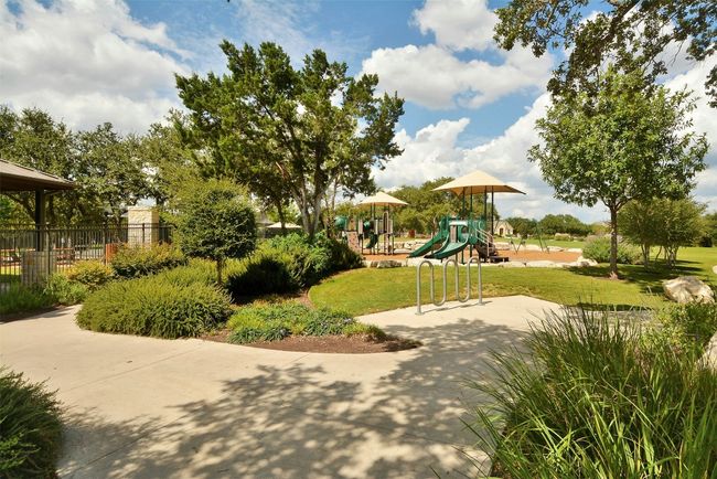 View of community with a lawn, fence, and playground community | Image 30