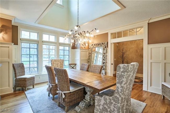 The formal dining room is located to the right of the foyer and also has hickory floors, plus transom windows over the double door entry from the foyer . There is a dormer window that adds to the natural lighting | Image 12